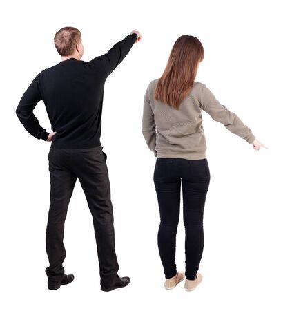 Back view of couple in sweater pointing. Rear view people collection. backside view of person. Isolated over white background.の写真素材