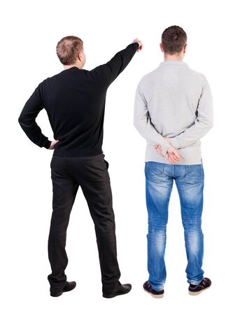 Back view of two man in sweater pointing. Rear view people collection. backside view of person. Isolated over white background.の写真素材
