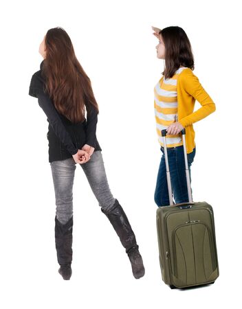 Back view of two woman in sweater traveling with suitcas. Back view. Rear view people collection. backside view of person. Isolated over white background.の写真素材