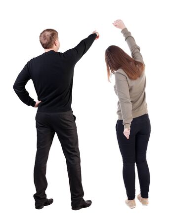 Back view of couple in sweater pointing. Rear view people collection. backside view of person. Isolated over white background.の写真素材