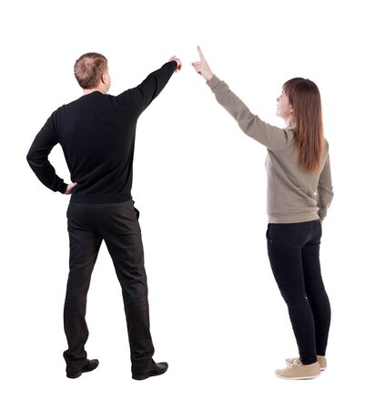 Back view of couple in sweater pointing. Rear view people collection. backside view of person. Isolated over white background.の写真素材