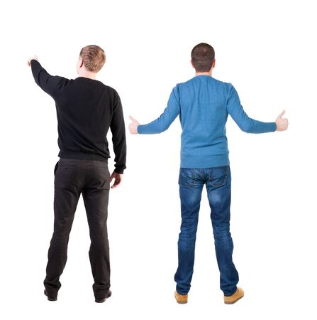 Back view of two man in sweater pointing. Rear view people collection. backside view of person. Isolated over white background.の写真素材