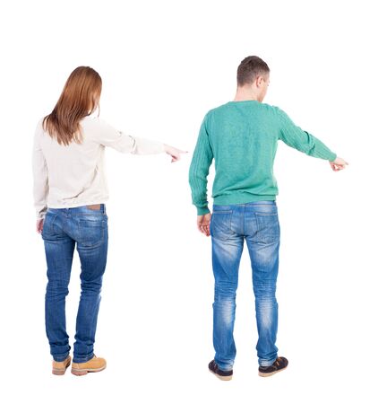 Back view of couple in sweater pointing. Rear view people collection. backside view of person. Isolated over white background.の写真素材