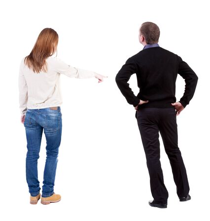 Back view of couple in sweater pointing. Rear view people collection. backside view of person. Isolated over white background.の写真素材