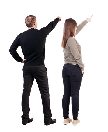 Back view of couple in sweater pointing. Rear view people collection. backside view of person. Isolated over white background.の写真素材