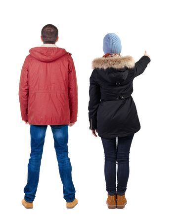 Back view of two pointing girl in winter jacket. Rear view people collection. backside view of person. beautiful woman friends showing gesture. Rear view. Isolated over white background.の写真素材