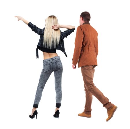 Back view of two pointing girl in winter jacket. Rear view people collection. backside view of person. beautiful woman friends showing gesture. Rear view. Isolated over white background.の写真素材