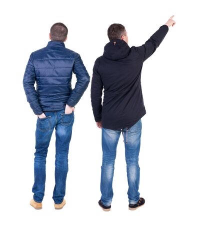 Back view of couple couple in winter jackets pointing. beautiful friendly girl and guy together. Rear view people collection. backside view of person. Isolated over white background.の写真素材