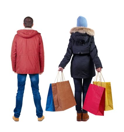 back view of couple with shopping bags in winter jacket. backside view of person. Rear view people collection. Isolated over white background.の写真素材