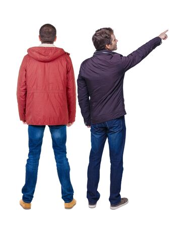Back view of couple couple in winter jackets pointing. beautiful friendly girl and guy together. Rear view people collection. backside view of person. Isolated over white background.の写真素材