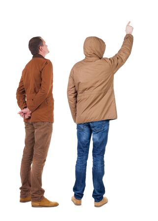 Back view of couple couple in winter jackets pointing. beautiful friendly girl and guy together. Rear view people collection. backside view of person. Isolated over white background.の写真素材
