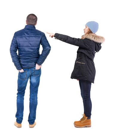 Back view of two pointing girl in winter jacket. Rear view people collection. backside view of person. beautiful woman friends showing gesture. Rear view. Isolated over white background.の写真素材