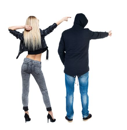Back view of two pointing girl in winter jacket. Rear view people collection. backside view of person. beautiful woman friends showing gesture. Rear view. Isolated over white background.の写真素材