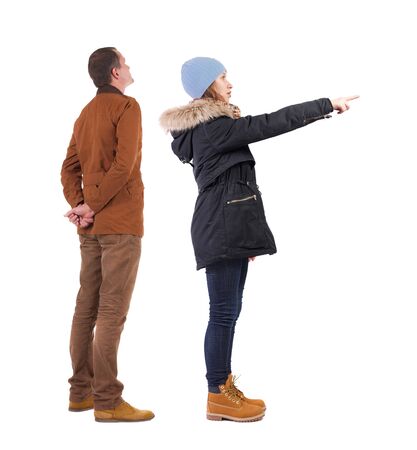 Back view of two pointing girl in winter jacket. Rear view people collection. backside view of person. beautiful woman friends showing gesture. Rear view. Isolated over white background.の写真素材