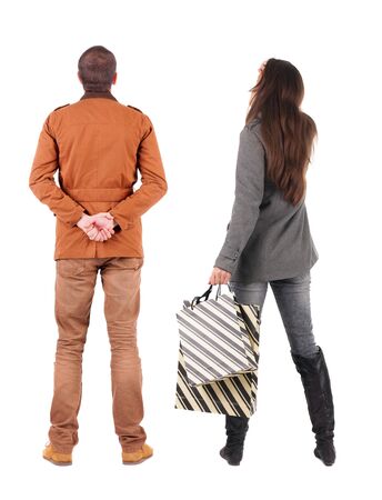back view of couple with shopping bags in winter jacket. backside view of person. Rear view people collection. Isolated over white background.の写真素材