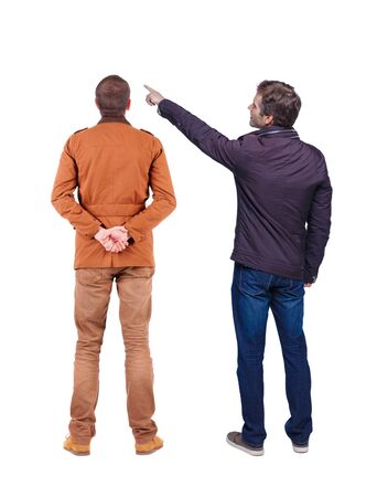 Back view of couple couple in winter jackets pointing. beautiful friendly girl and guy together. Rear view people collection. backside view of person. Isolated over white background.の写真素材