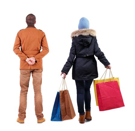 back view of couple with shopping bags in winter jacket. backside view of person. Rear view people collection. Isolated over white background.の写真素材