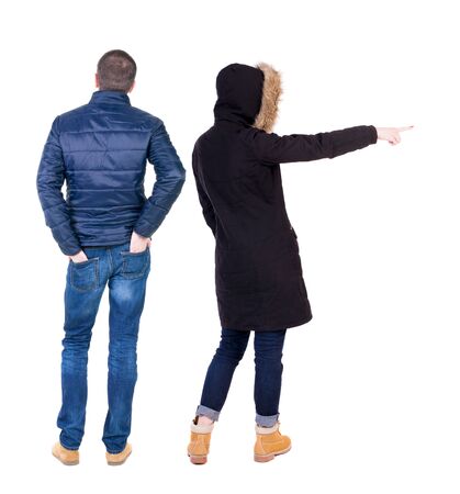 Back view of two pointing girl in winter jacket. Rear view people collection. backside view of person. beautiful woman friends showing gesture. Rear view. Isolated over white background.の写真素材