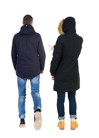 Back view of two pointing girl in winter jacket. Rear view people collection. backside view of person. beautiful woman friends showing gesture. Rear view. Isolated over white background.の写真素材