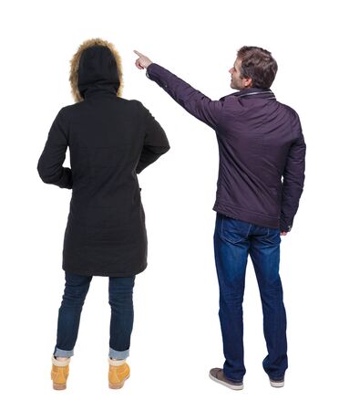 Back view of two pointing girl in winter jacket. Rear view people collection. backside view of person. beautiful woman friends showing gesture. Rear view. Isolated over white background.の写真素材