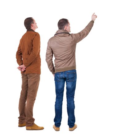 Back view of couple couple in winter jackets pointing. beautiful friendly girl and guy together. Rear view people collection. backside view of person. Isolated over white background.の写真素材