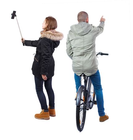 Back view of couple in winter jacket. man on a bicycle and a woman. Rear view people collection. backside view of person. Isolated over white background.の写真素材