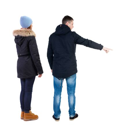 Back view of two pointing girl in winter jacket. Rear view people collection. backside view of person. beautiful woman friends showing gesture. Rear view. Isolated over white background.の写真素材