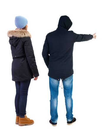 Back view of two pointing girl in winter jacket. Rear view people collection. backside view of person. beautiful woman friends showing gesture. Rear view. Isolated over white background.の写真素材