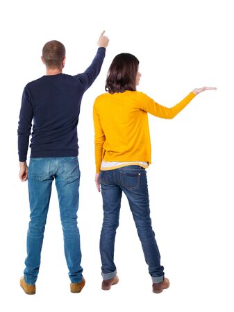 Back view of couple in sweater pointing. Rear view people collection. backside view of person. Isolated over white background.の写真素材