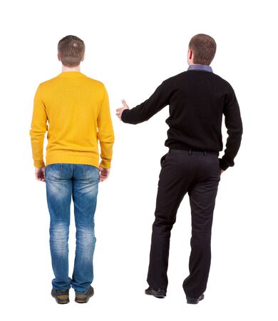Back view of two man in sweater pointing. Rear view people collection. backside view of person. Isolated over white background.の写真素材