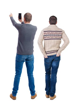 Back view of two man in sweater with mobile phone. Rear view people collection. backside view of person. Isolated over white background.の写真素材