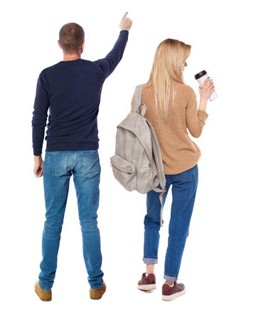 Back view of couple in sweater pointing. Rear view people collection. backside view of person. Isolated over white background.の写真素材