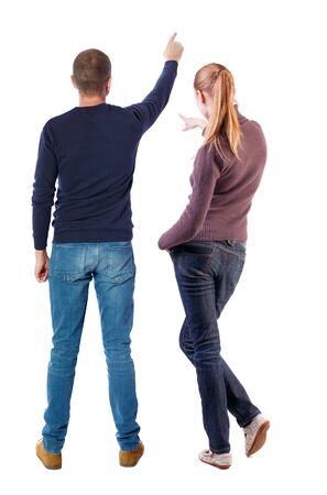 Back view of couple in sweater pointing. Rear view people collection. backside view of person. Isolated over white background.の写真素材