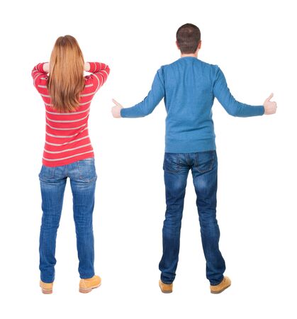 Back view of couple in sweater showing thumbs up. beautiful woman and man together. Rear view people collection. backside view of person. Isolated over white background.の写真素材