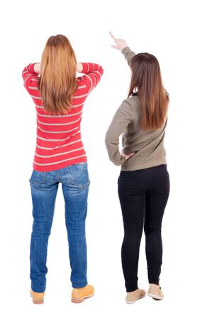 Back view of two pointing girl in sweater. Rear view people collection. backside view of person. beautiful woman showing gesture. Rear view. Isolated over white background.の写真素材