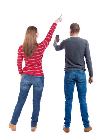 Back view of couple in sweater with mobile phone. beautiful friendly girl and guy together. Rear view people collection. backside view of person. Isolated over white background.の写真素材
