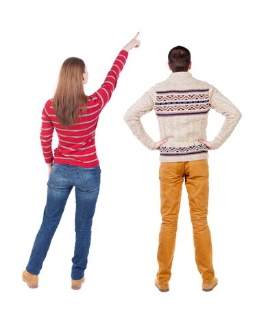 Back view of couple in sweater pointing. Rear view people collection. backside view of person. Isolated over white background.の写真素材