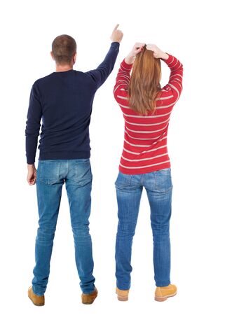 Back view of couple in sweater pointing. Rear view people collection. backside view of person. Isolated over white background.の写真素材