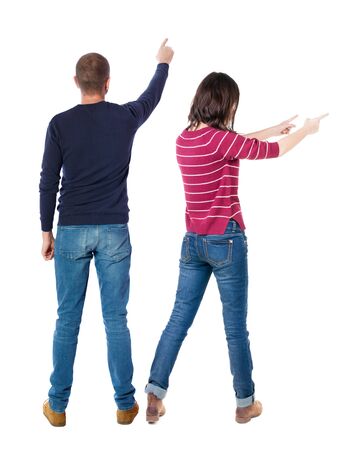 Back view of couple in sweater pointing. Rear view people collection. backside view of person. Isolated over white background.の写真素材