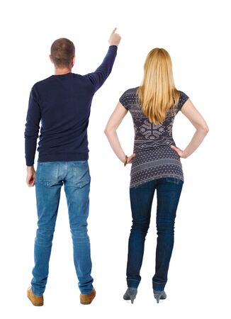 Back view of couple in sweater pointing. Rear view people collection. backside view of person. Isolated over white background.の写真素材