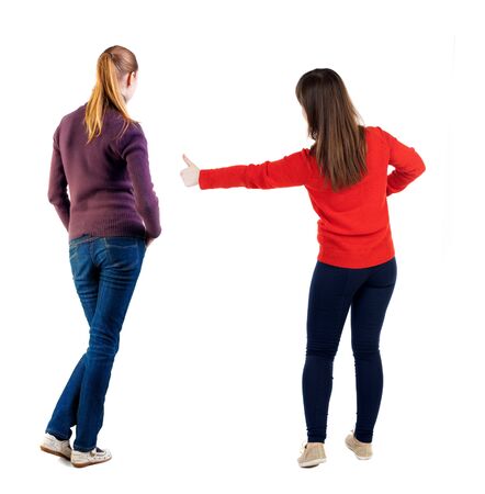 Back view of couple in sweater showing thumbs up. beautiful woman and man together. Rear view people collection. backside view of person. Isolated over white background.の写真素材