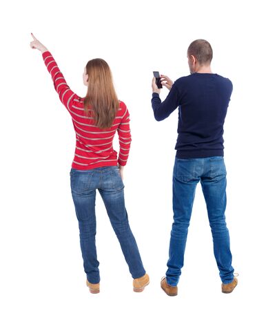Back view of couple in sweater with mobile phone. beautiful friendly girl and guy together. Rear view people collection. backside view of person. Isolated over white background.の写真素材