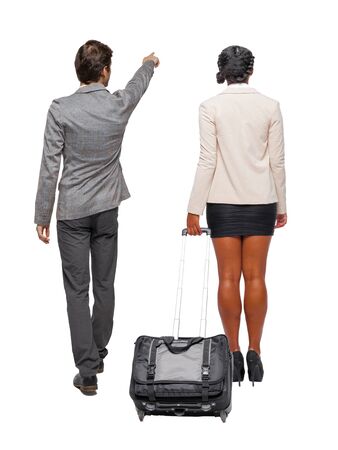 Back view of two business people in suit pointing. Business team. traveling with suitcas. Back view. Rear view people collection. backside view of person. Isolated over white background.の写真素材