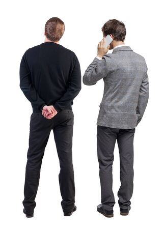 Back view of two business man in suit with mobile phone. Business team. view people collection. backside view of person. Isolated over white background.の写真素材