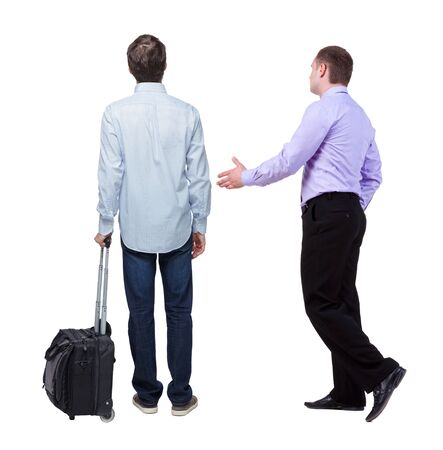 Back view of two business men in suit pointing. Business team. traveling with suitcas. Rear view people collection. backside view of person. Isolated over white background.の写真素材