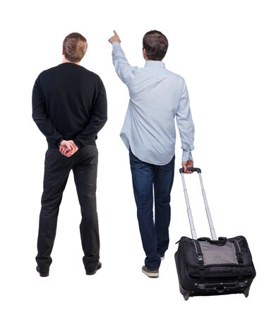 Back view of two business men in suit pointing. Business team. traveling with suitcas. Rear view people collection. backside view of person. Isolated over white background.の写真素材