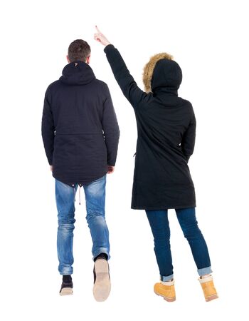 Back view of two pointing girl in winter jacket. Rear view people collection. backside view of person. beautiful woman friends showing gesture. Rear view. Isolated over white background.の写真素材