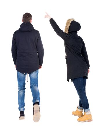 Back view of two pointing girl in winter jacket. Rear view people collection. backside view of person. beautiful woman friends showing gesture. Rear view. Isolated over white background.の写真素材