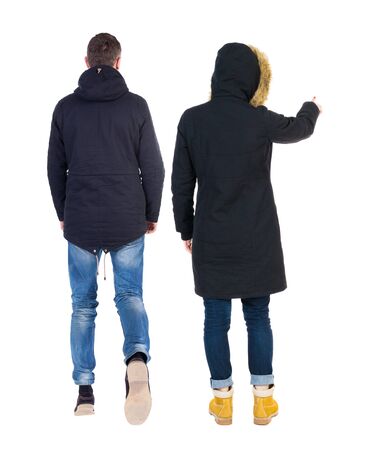 Back view of two pointing girl in winter jacket. Rear view people collection. backside view of person. beautiful woman friends showing gesture. Rear view. Isolated over white background.の写真素材