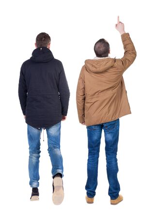 Back view of couple couple in winter jackets pointing. beautiful friendly girl and guy together. Rear view people collection. backside view of person. Isolated over white background.の写真素材